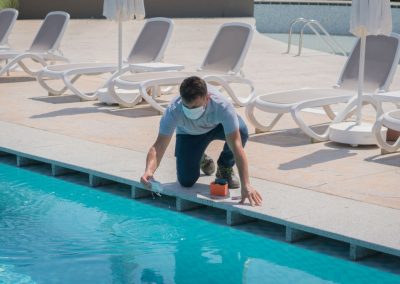 a man testing the pool water using a kit